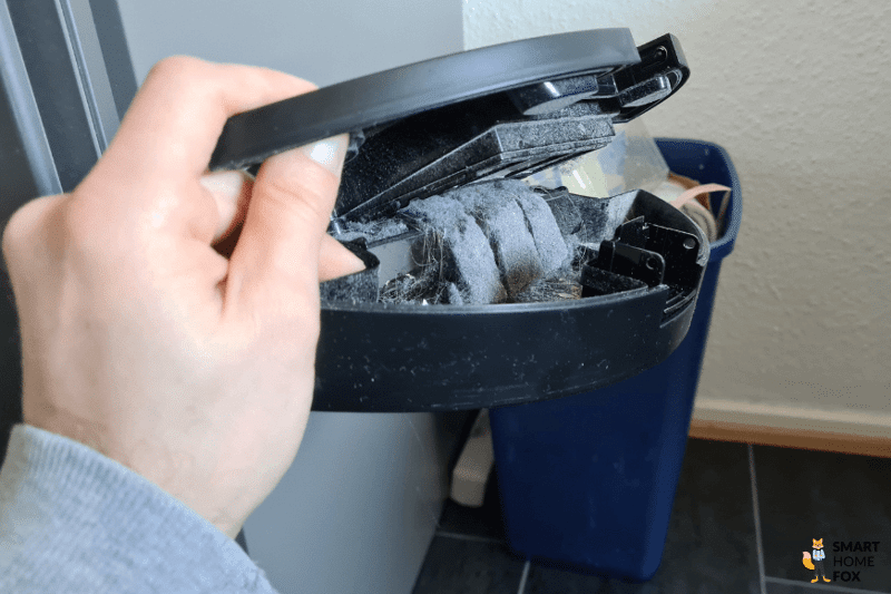 Der mobile Staubbehälter eines Shark Saugroboters wird entleert.